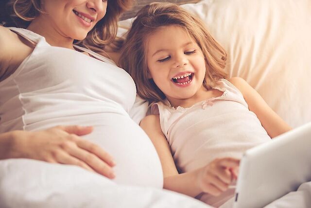 mother and daughter reading ipad